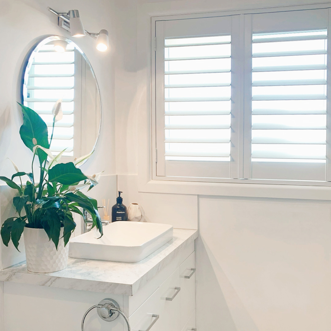 Renovated ensuite featuring a Plantation Shutter next to the vanity.