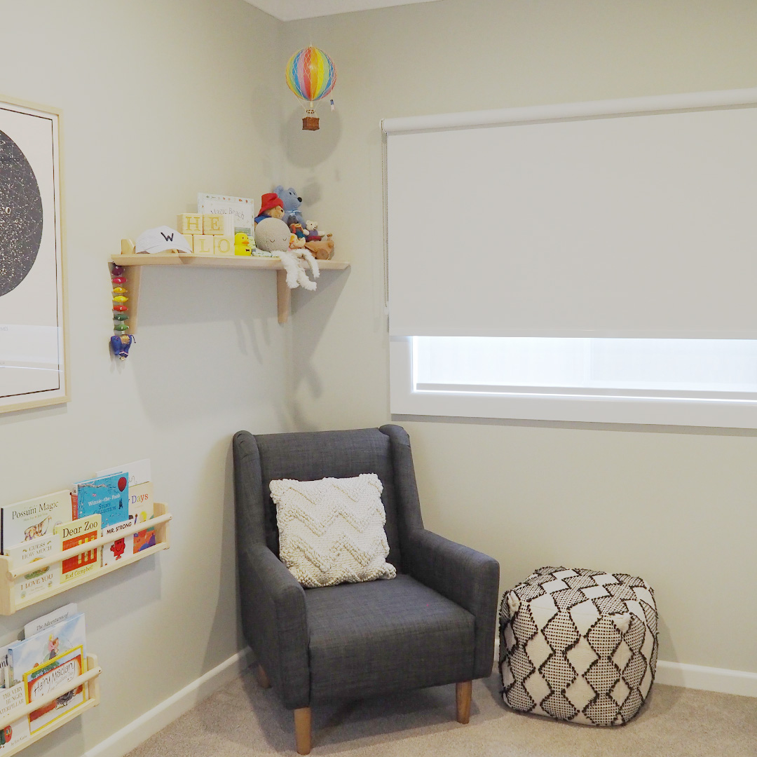 White blockout roller blind in a beautifully styled nursery with lots of natural light.