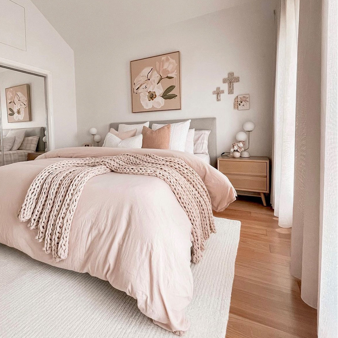 Beautiful contemporary bedroom with warm, soft colours and sheer curtains to match.